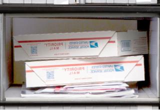 Medium PO Box, Size 3, with small packages stacked on top of magazines and large envelopes.